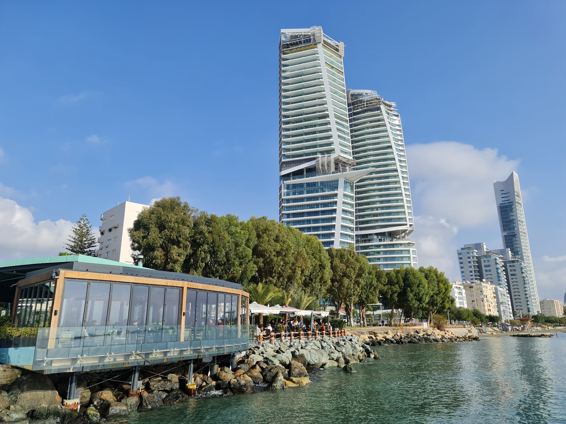 Limassol seafront with the iconic twin high-rise residential towers viewed from a glass restaurant on the rocks